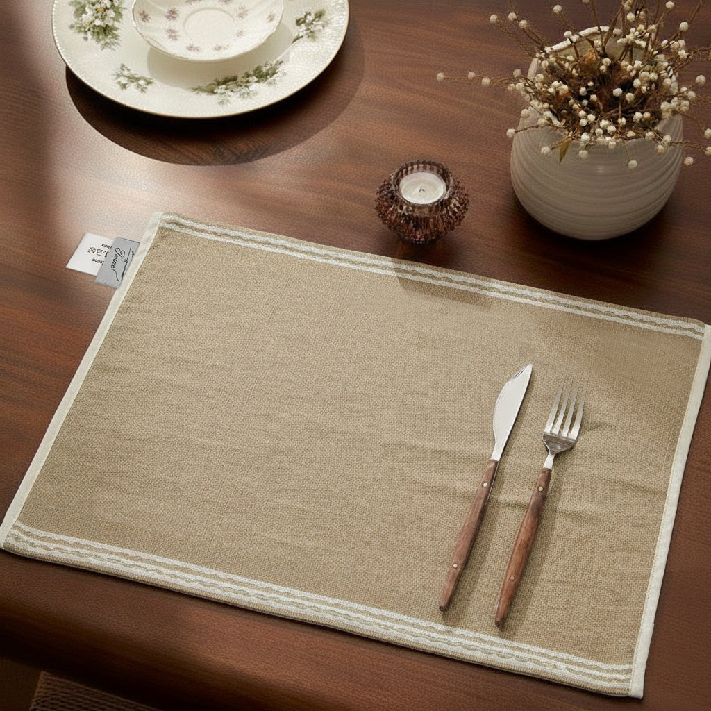Natural beige chambray placemat with stitched white border and soft finish